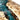 Handcrafted poplar resin table with live edge inspired wood character, transparent blue epoxy accents, and elegant craftsmanship as a premium wood dining table ---- BespokeTableCo