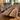 Black walnut wood epoxy table with built-in power integration and a deep black resin river, combining natural elegance with modern functionality - BespokeTableCo