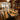 Solid wood dining room table featuring a live edge olive wood slab and crystal-clear resin, creating a stunning centerpiece for modern and rustic interiors alike - BespokeTableCo