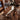 A handcrafted solid wood dining table with premium black walnut wood slabs and a smooth white resin inlay, creating a warm and sophisticated dining space with contemporary style - BespokeTableCo