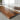 Close-up detail of a black walnut resin dining table highlighting the natural grain patterns of black walnut wood and the smooth epoxy finish of a solid wood dining table - BespokeTableCo
