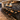 A premium Burl Cedar epoxy table designed for a luxury bar counter, combining natural timber character with deep resin accents in a contemporary lounge area - BespokeTableCo