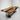 A modern conference table display featuring black walnut slab with black resin inlay, showcased in a bright studio setting for corporate interior design presentation - BespokeTableCo