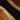 Close-up detail of custom black walnut epoxy resin table showing natural wood grain and glossy resin finish on handcrafted dining table wood - BespokeTableCo