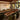 Custom black walnut epoxy resin table featuring a beveled edge and full glossy finish, placed in an elegant dining room with modern chairs, creating a luxury dining table wood centerpiece - BespokeTableCo
