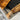 Custom epoxy resin black walnut dining table detail showing natural live edge dining table contours and smooth resin table inlay craftsmanship - BespokeTableCo