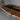 Handcrafted black walnut dining room table detail with epoxy resin river design, polished finish, and distinctive top table top texture - BespokeTableCo