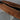 Custom epoxy resin black walnut dining table detail showing rich walnut grain on a solid wood dining table with a smooth black epoxy table surface - BespokeTableCo