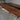 Close-up view of custom epoxy resin black walnut dining room table showing natural wood grain, flowing resin details, and a refined table top top finish - BespokeTableCo