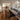Modern epoxy resin black walnut dining room table with natural edges and a handcrafted top table top displayed in a bright residential dining room setting - BespokeTableCo