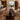 Custom epoxy resin black walnut dining table featuring a natural solid wood dining table surface and elegant epoxy table design in a warm interior space - BespokeTableCo