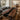 Custom epoxy resin black walnut dining room table with a live edge wood design and black resin river feature placed in a modern dining room, highlighting the natural top table top - BespokeTableCo