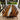 Custom epoxy resin black walnut dining table styled as an outdoor wood dining table with a unique resin table center design surrounded by a relaxing patio setting - BespokeTableCo