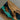 Close-up of a live edge coffee table showing the organic edge contour where wood meets translucent turquoise resin - BespokeTableCo