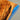 Surface detail of a custom epoxy resin table capturing the striking contrast between the warm olive wood tones and the vivid blue glossy resin river - BespokeTableCo