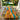Custom epoxy resin olive wood dining table featuring a flowing turquoise river channel, placed in a sunlit dining space with warm natural light and views of a lush outdoor garden and swimming pool - BespokeTableCo