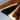 Detailed view of epoxy resin table top with rich walnut textures, smooth glossy coating, and handcrafted edge details for a premium solid wood dining table - BespokeTableCo