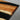 Custom epoxy resin walnut dining table detail featuring the seamless blend of solid walnut wood and polished resin, creating a distinctive solid wood dining table design - BespokeTableCo