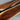 Close-up craftsmanship detail of custom epoxy resin walnut dining table highlighting unique wood patterns and flowing resin accents in an elegant epoxy resin table top - BespokeTableCo