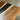 Surface detail of a custom epoxy resin countertop capturing the striking contrast between the warm walnut wood and the deep black resin stripe - BespokeTableCo