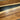 Close-up of a live-edge countertop showing the organic edge contour where the walnut meets the black resin - BespokeTableCo