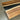 Detail of wood slabs for countertops highlighting the natural walnut grain texture and the polished glossy resin surface - BespokeTableCo