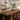 A handcrafted wood countertop made from walnut with a dramatic black resin stripe, positioned on a kitchen island in a sunlit contemporary kitchen with white cabinetry - BespokeTableCo