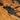 Custom resin table detail featuring olive wood texture, integrated power outlet design, and refined finishing for executive conference room tables - BespokeTableCo
