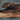 Close-up detail of resin walnut coffee table showing natural wood grain and smooth epoxy tables tabletop finish - BeSpokeTableCo