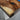 Walnut dining table detail showing the seamless combination of handcrafted wood texture and epoxy resin inlay for a modern dining room - BeSpokeTableCo