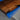 Detailed view of walnut epoxy table surface featuring a transparent blue resin river and unique natural patterns on the dining room table top - BeSpokeTableCo