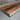 Close-up detail of a live-edge walnut wood dining table showing natural grain patterns, smooth turquoise resin river, and the organic edge where wood meets the polished top table top - BespokeTableCo