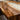 Selecting premium Walnut slabs for a custom river table. Luxury walnut dining room table with a sculptural resin river, combining natural edge character with modern elegance for sophisticated interiors - BespokeTableCo