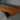 Close-up of a walnut resin wood dining table surface capturing the interplay of natural wood texture and translucent turquoise resin, the river channel across the polished natural wood table top - BespokeTableCo